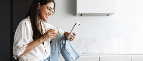 woman holding a phone to conduct her banking